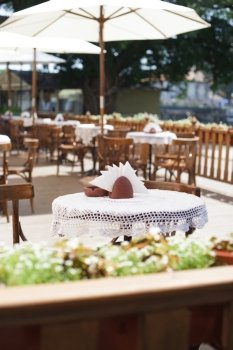 Cafe with rustic tableware and chairs outdoors