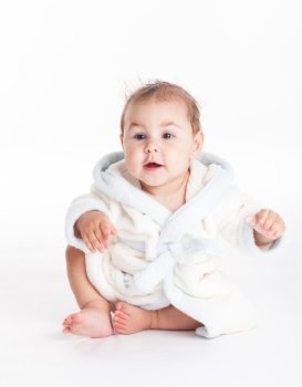 Baby in a bathrobe after bath with wet head