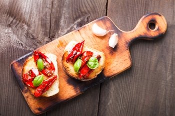 Bruschetta with sun dried tomatoes, basil leaves and garlic