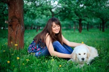 Girl play with golden retriever in park