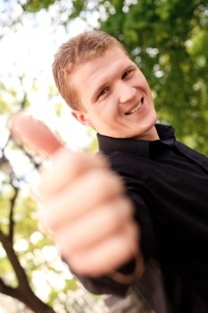 Blonde man outdoor with thumb up
