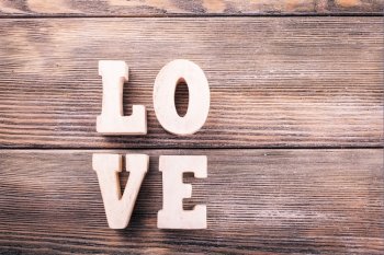 Wooden letters LOVE on a wooden background