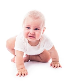 Crying baby tries to craw, isolated on white background
