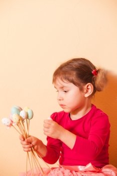 Girl is doing an Easter handmade decorations for holiday. Girls on an Easter Egg hunt