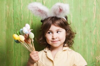 Girl with bunny ears and little eggs. Easter celebration. Girl with bunny ears 