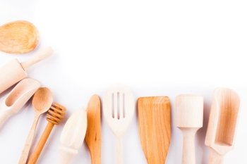 Assortment of wooden kitchen utensils on a white background with copy space. Wooden utensils 