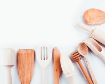Assortment of wooden kitchen utensils on a white background. Wooden utensils 