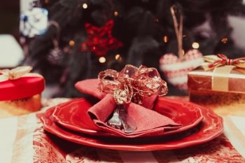 Tableware that performed in red on a background of the Christmas tree. The Christmas tableware