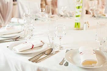 White beautiful table set for a wedding dinner. White wedding table set 