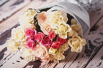 Luxury bouquet of roses lying on a wooden board. Bouquet of roses