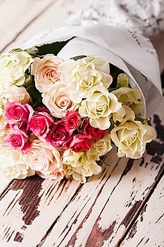 Luxury bouquet of roses lying on a wooden board. Bouquet of roses