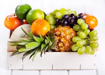 fresh fruits in a box on wooden table