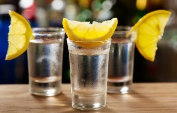 cold glasses of vodka with lemon