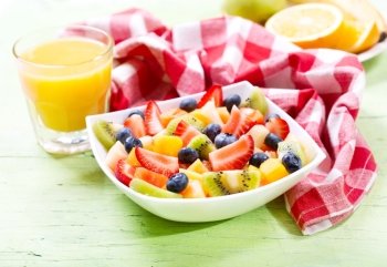 bowl of fruit salad on wooden table
