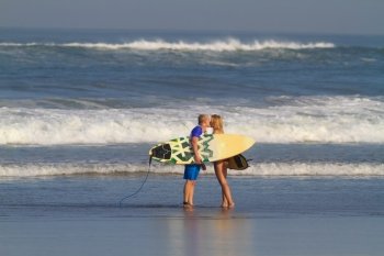 Surfer Woman and Man with Surfboards.