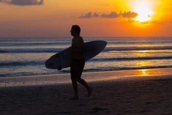 Surfer Watching the Waves at Sunset.