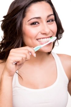 Smiling young woman with healthy teeth holding a tooth brush
