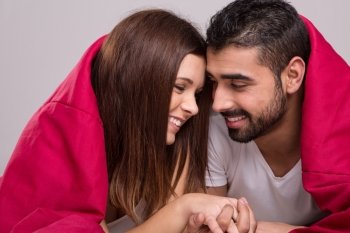 Young love couple relaxing together in bed