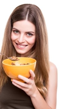 Happy fit woman eating cereals with milk bowl