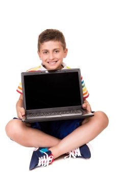 Cute blond boy using a personal computer