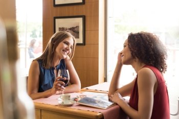Pretty women talking and having fun inside coffee shop