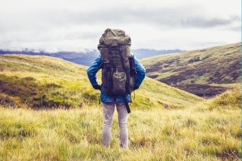 Hiker standing in the wilderness with backpack