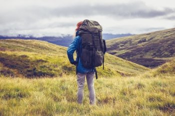 Hiker standing in the wilderness with backpack