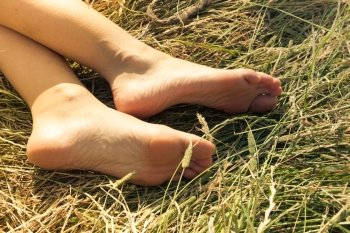 Woman’s bare feet in the grass