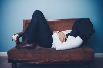 Young businessman sleeping on a sofa