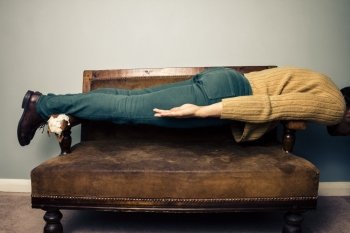Young man lying on a sofa