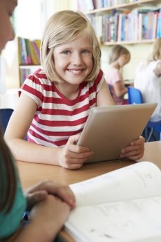 Elementary School Pupil Using Digital Tablet In Classroom