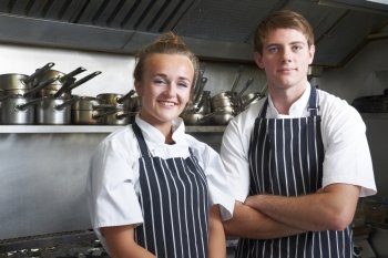 Portrait Of Chef And Trainee In Kitchen