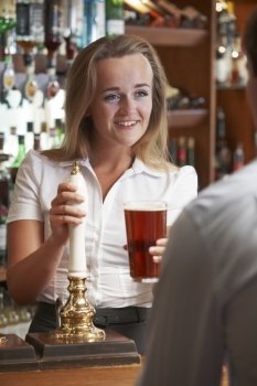Female Bartender Serving Drink To Male Customer