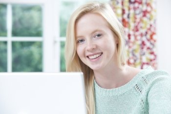 Portrait Of Teenage Girl Using Computer At Home