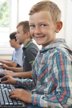 Group Of Male Elementary School Children In Computer Class