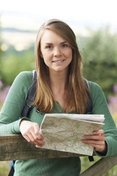 Portrait Of Woman Hiking In Countryside Looking At Map