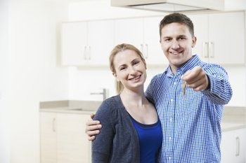 Happy Young Couple Holding Keys To New Home