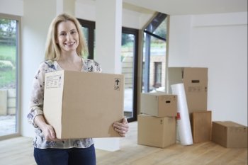 Woman Moving Into New Home With Packing Box