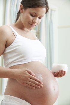 Pregnant Woman Moisturizing Belly