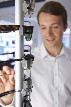 Man Choosing Glasses In Opticians