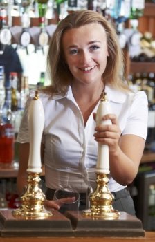 Female Bartender Serving Drink To Customer