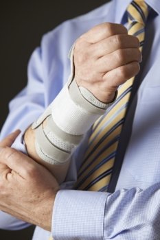 Close Up Of Businessman Suffering With Repetitive Strain Injury (RSI)