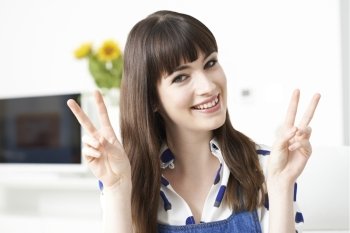Young Woman Making Peace Gesture With Hands