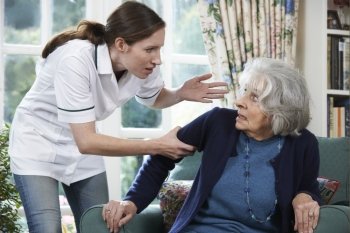 Care Worker Mistreating Senior Woman At Home