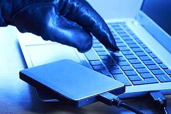 Cyber Criminal Downloading Data Onto Portable Hard Drive