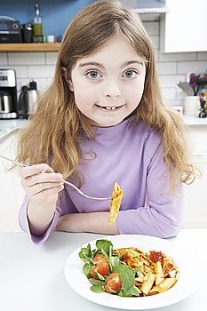 Portrait Of Girl Enjoying Healthy Meal At Home