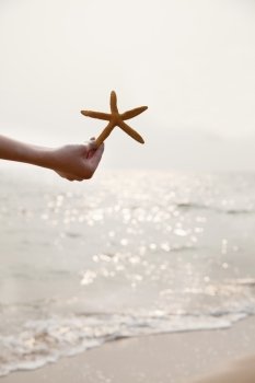Young Woman Holding Starfish