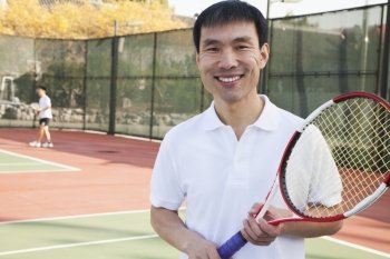 Adult men playing tennis, portrait