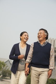 Senior couple going for a stroll in Beijing, holding hands