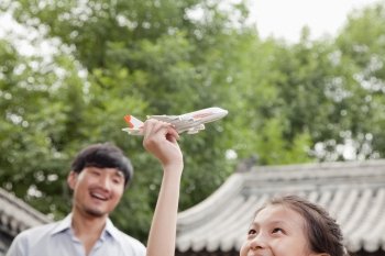 Girl Playing with Airplane